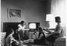 A 1950s American family gathered around a television set at home