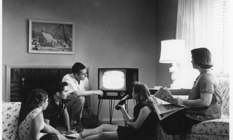 A 1950s American family gathered around a television set at home