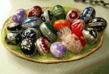 Colourful decorated Easter eggs arranged on straw for spring celebration