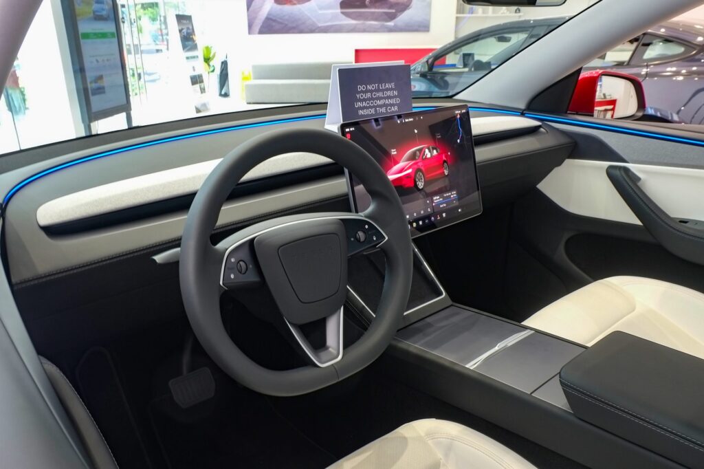 Tesla Model Y interior with large central touchscreen and minimalist dashboard